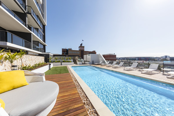outdoor lap pool with sun loungers at The Milton Brisbane hotel opposite XXXX brewery and Suncorp Stadium