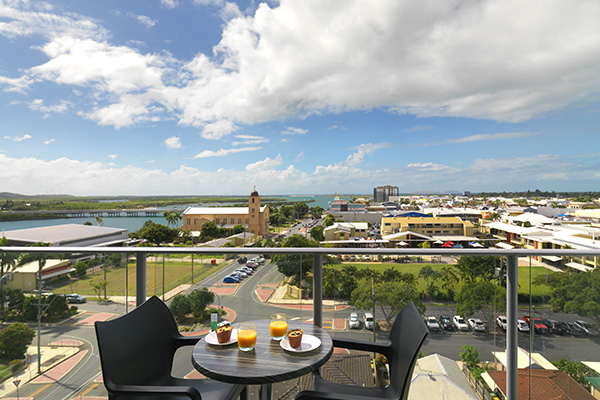 breakfast on table on private balcony of two bedroom executive apartment at Oaks Rivermarque hotel in Mackay, Queensland, Australia