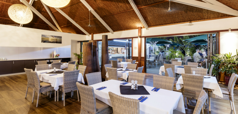 indoor air conditioned dining area with tables and chairs ready for guests at Cables Restaurant and Bar in Cable Beach, Broome, Australia